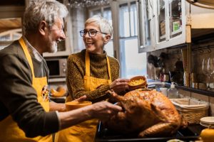 senior-couple-in-kitchen-with-turkey