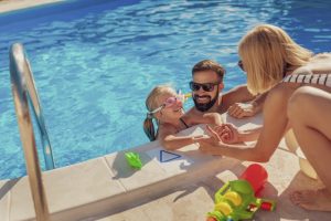 man-woman-child-in-swimming-pool